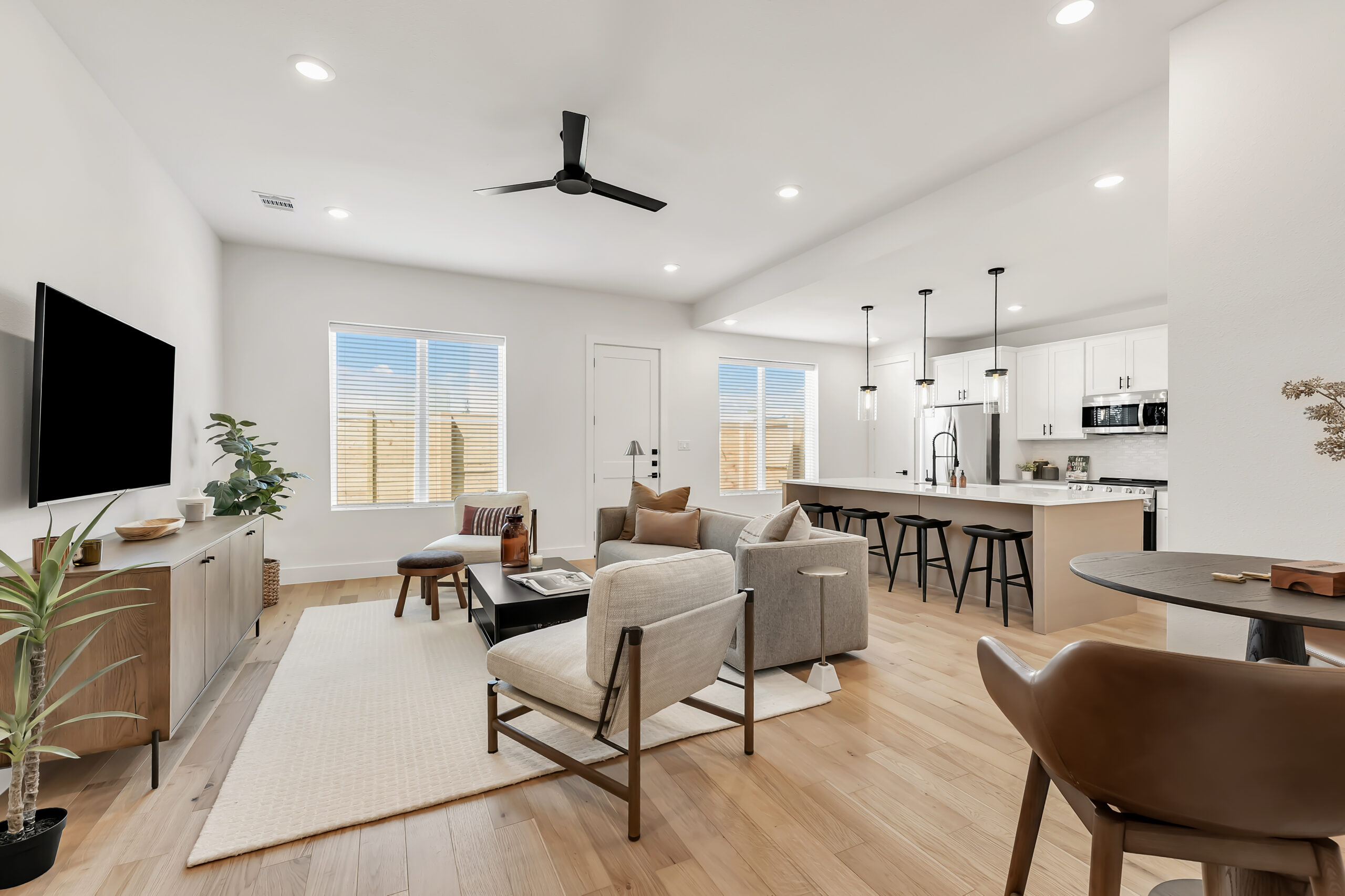 Open-concept living area with hardwood floors and 10-foot ceilings