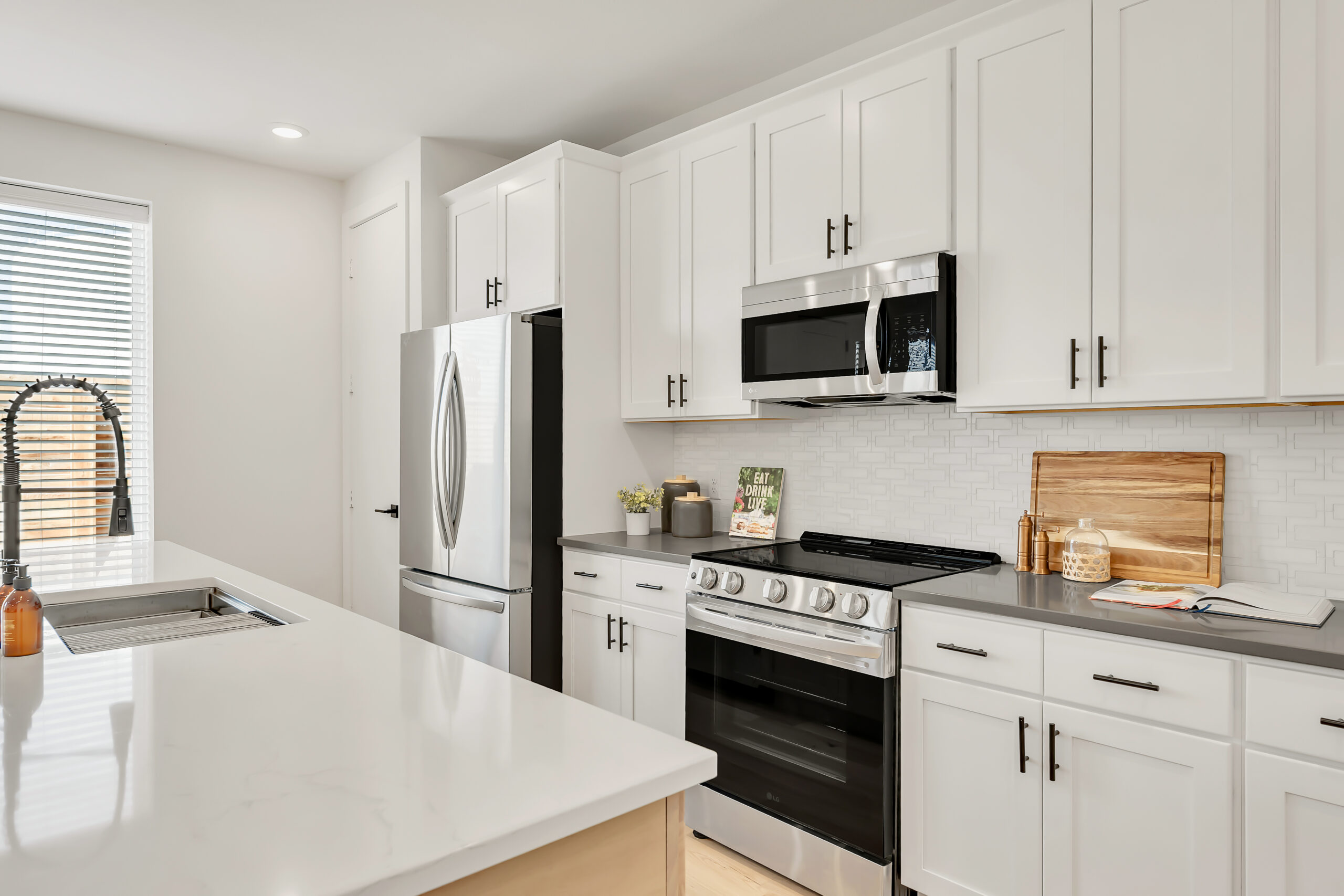 Kitchen detail with shaker cabinetry and quartz counters
